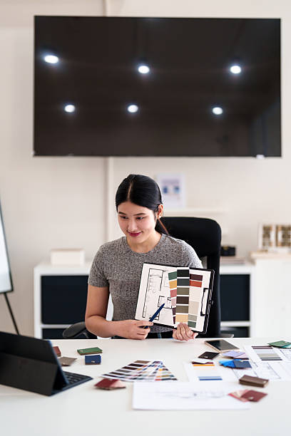 istock Young architect presenting interior design ideas through tablet during online meeting in creative office 2217047634