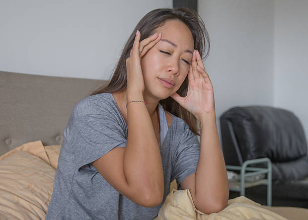 istock Woman Suffering Morning Headache in Bed 2217047663