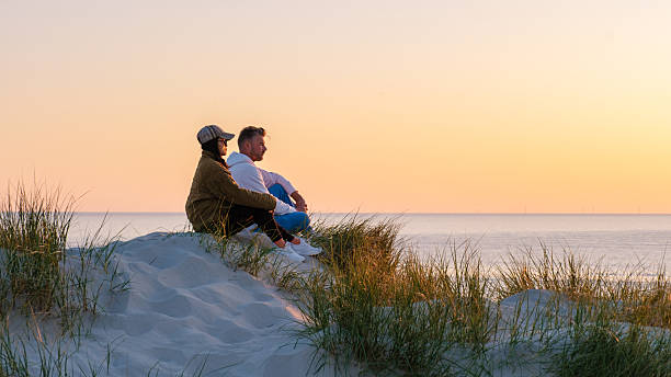 istock Couple enjoying sunset together on a sandy beach in Denmark 2217048189