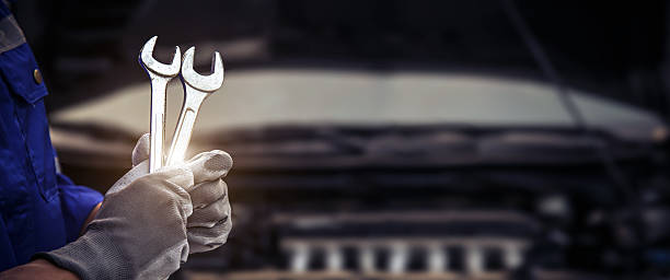 istock Car care maintenance and servicing, Close-up hand technician auto mechanic using the wrench to repairing change spare part car engine problem and car insurance service support. 2217051857