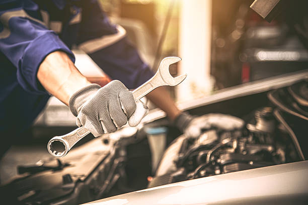 istock Car care maintenance and servicing, Close-up hand technician auto mechanic using the wrench to repairing change spare part car engine problem. Concepts of check and during periodic inspection service. 2217051878