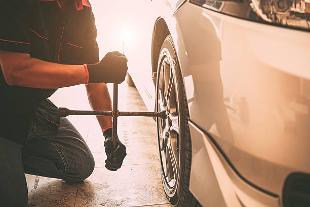 istock Car care maintenance and servicing, Close-up hand technician auto mechanic using wrench change tire concept of repairing and fix car problem and insurance service support. 2217053034