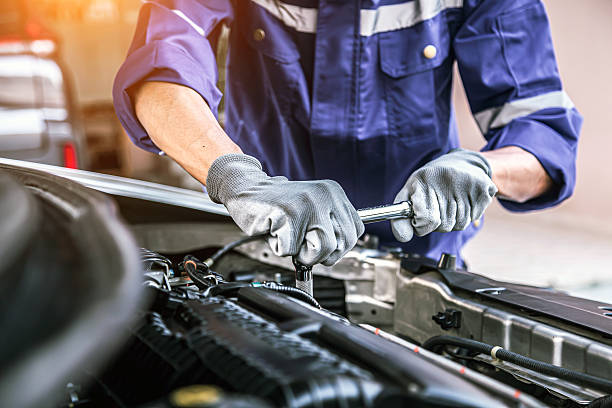 istock Car care maintenance and servicing, Close-up hand technician auto mechanic using the wrench to repairing change spare part car engine problem and car insurance service support. 2217053055