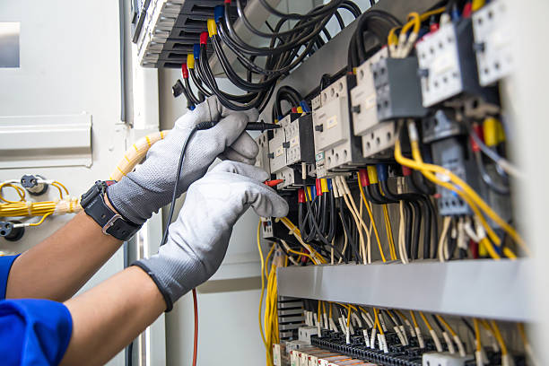 istock Electricity and electrical maintenance service, Engineer using measuring equipment tool checking electric current voltage at circuit breaker terminal and cable wiring main power distribution board. 2217054350