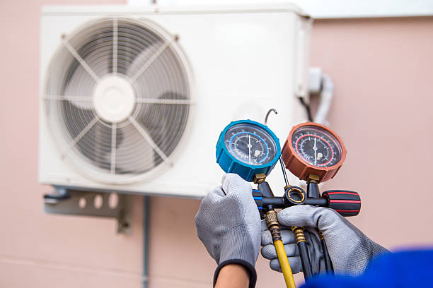 istock Mechanic air conditioner technician using manifold gauge checking refrigerant for filling home air conditioning and air duct cleaning and maintenance outdoor compressor unit. 2217054412
