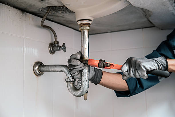 istock Technician plumber using a wrench to repair a water pipe under the sink. Concept of maintenance, fix water plumbing leaks, replace the kitchen sink drain, cleaning clogged pipes is dirty or rusty. 2217054442
