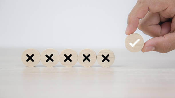 istock Hand choose check mark on wooden toy stack with cross symbol for true or false changing mindset or way of adapting to change leader and transform quiz answer and poll concept 2217054448