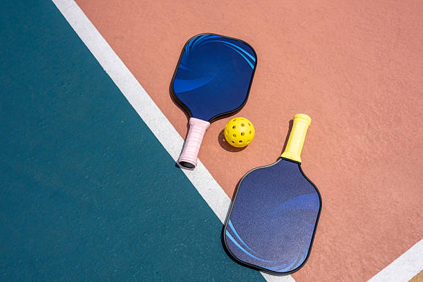 istock Paddles and Ball on Vibrant Court 2217060358