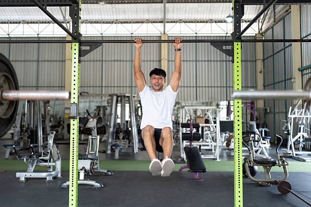 istock Fitness Enthusiast: Young Man Hanging on Gym Bar, Smiling 2217063079