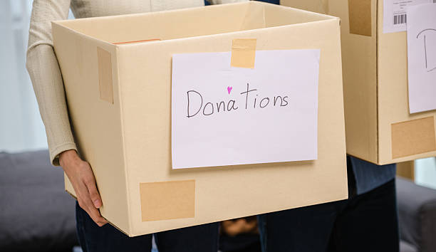 istock group of friend  sorting and packing clothes into a donation box.community support, and charitable giving 2217063601
