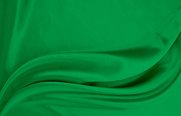 istock Black green satin dark fabric texture luxurious shiny that is abstract silk cloth background with patterns soft waves blur beautiful. 2217064029