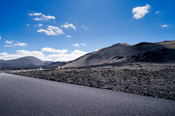 A road in the middle of the desert, black sand and the volcanic wild landscape of the Island, Canary Islands.