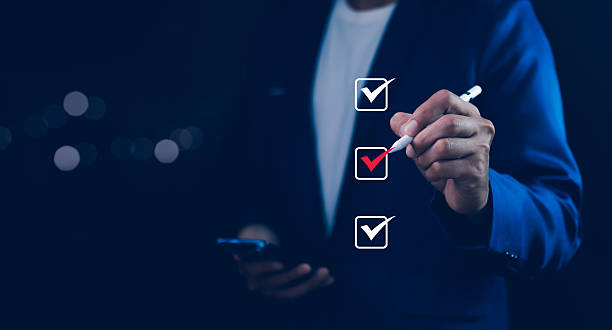 istock Businessman tick correct mark to approve document iso checklist icon.checkmark quality management quality assurance or QA and quality control or QC and improvement, Standardization and certification. 2217065040
