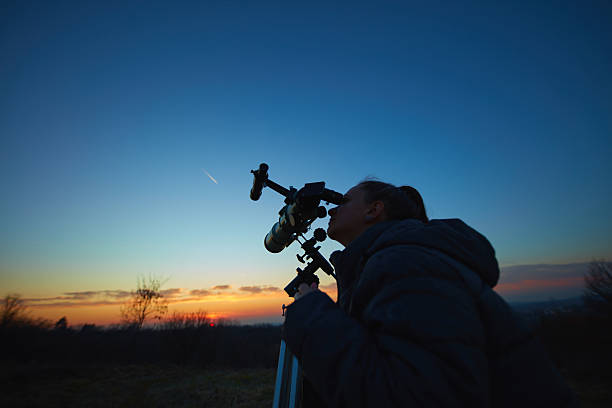istock Amateur astronomer using telescope for watching stars, Moon, planets and other celestial objects from a field in nature. 2217067428
