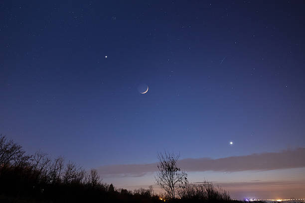 istock Crescent young Moon with stars, planets and countryside silhouettes. 2217067523