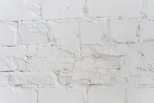 istock Weathered white brick wall showcasing texture and character over time 2217067826