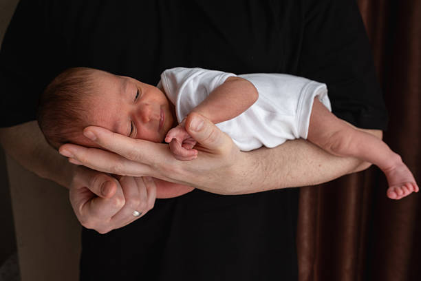 istock Newborn Baby Cradled in Hand 2217069438
