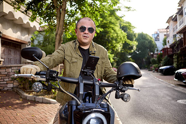 istock Middle-aged Chinese man riding a motorcycle 2217069963