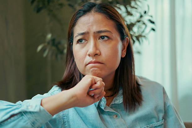 istock Close-up woman face thinking and stressed on the sofa. 2217072002
