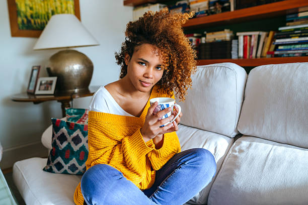 istock Woman with cup at home, looking at camera 2217073020