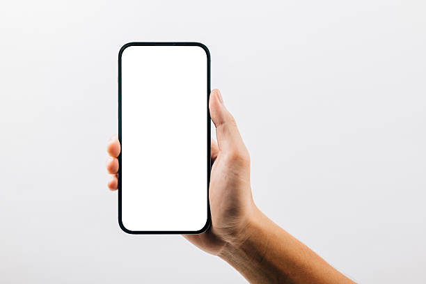 istock A hand holding a black cell phone isolated on white background, Man hand holding black smartphone mockup blank screen display 2217073907