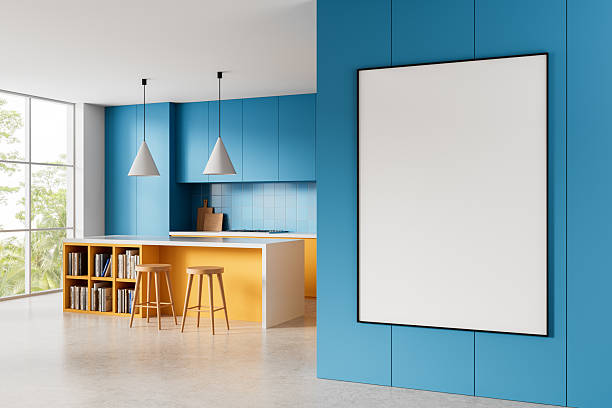 istock Blank framed poster mockup on blue wall in bright modern kitchen interior with yellow accents and clean minimalist layout concept for advertising display. 3D Rendering 2217074168