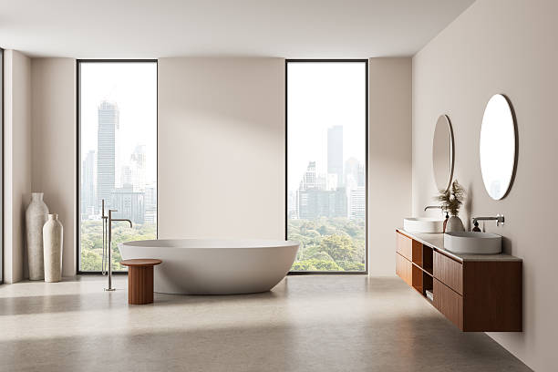 istock Minimalist luxury bathroom interior with freestanding bathtub, wooden vanity with double sinks and large windows overlooking cityscape, serene atmosphere. 3D Rendering 2217074915