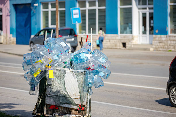 istock Man riding a bicycle with trailer with plastic bottles, waste exporting for recycle 2217075500