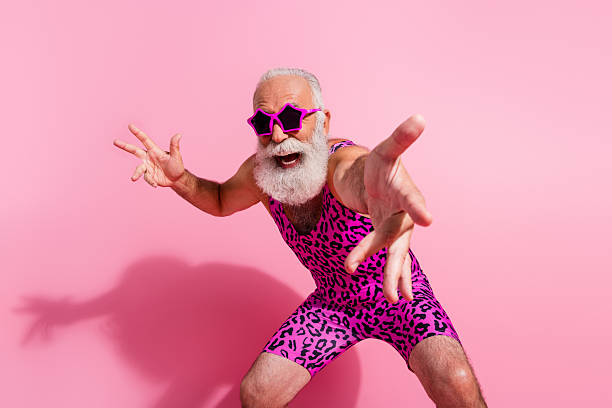 Photo of glamour senior man have fun dancing wear leopard print swimsuit isolated pink color background Photo of glamour senior man have fun dancing wear leopard print swimsuit isolated pink color background. gay man men sunglasses party stock pictures, royalty-free photos & images