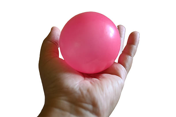 istock Hand holding a pink plastic ball 2217077990