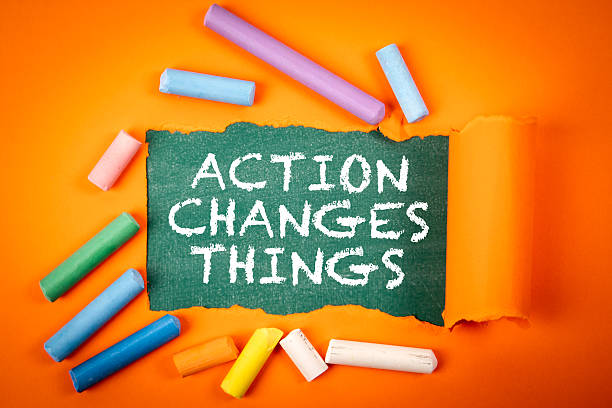 istock ACTION CHANGES THINGS Concept with Torn Paper and Colorful Chalk on Orange Background 2217082318