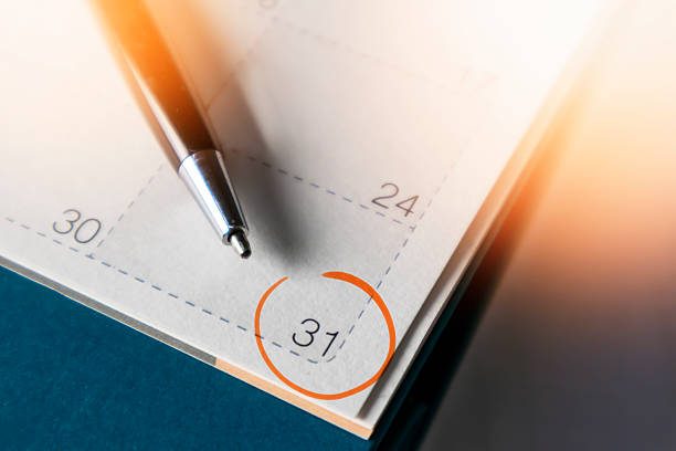 Black business pen on calendar background. Appointment planning work schedule.