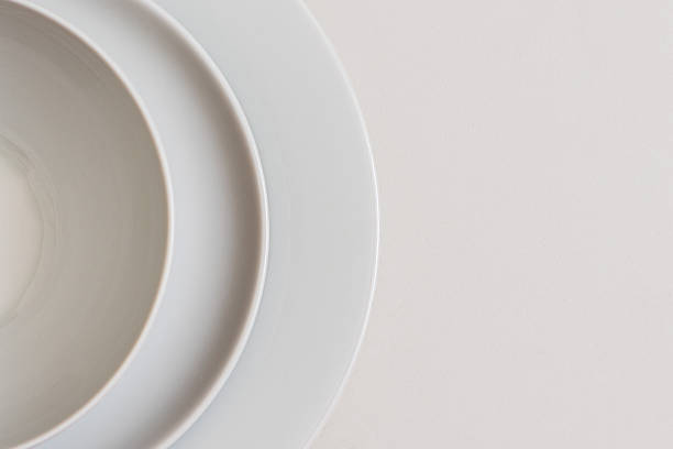 Culinary minimalism: composition of white plates on white background.Concepts.