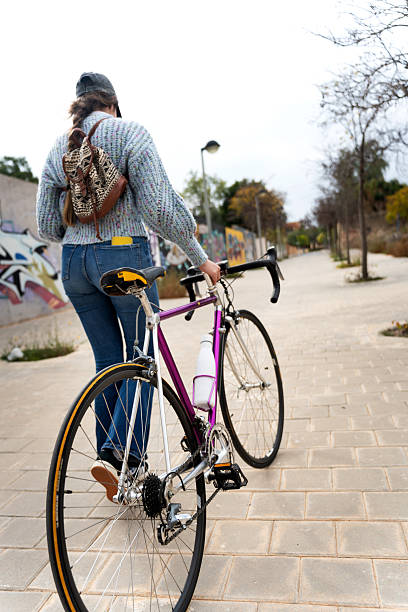 istock University student walking with her vintage bicycle in urban setting 2217087832