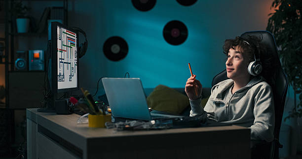 istock In a quiet room, the student works on a school task, surrounded by screens. He sketches ideas in a notebook and uses the computer to plan and visualize his concept. 2217088379