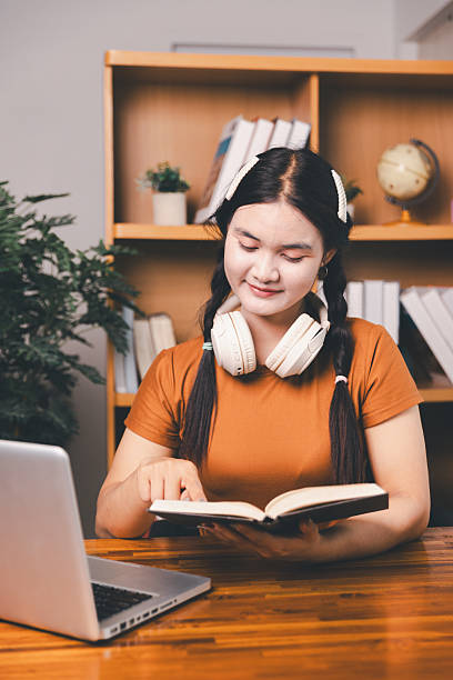 istock Homeschool Asian girl student learning virtual internet online class from school teacher by remote meeting. Female teaching math by headphone. education concept. student with computer study at school 2217088741