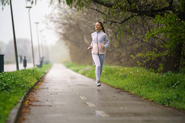 istock Girl jogging during overcast weather in park 2217089271