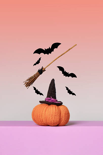 Happy Halloween, magic spell and flying broomstick concept with text frame by broom and witch or wizard hat on white background with copy space and a clip path cutout