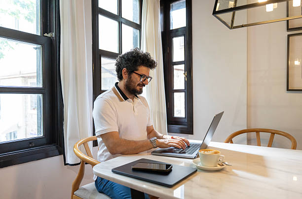 istock Confident businessman working remotely from cozy cafe 2217091972