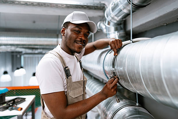 istock Skilled worker performs maintenance on industrial piping in a modern facility during daytime 2217091979
