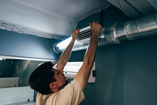istock Maintenance professional installs ventilation system in modern interior during daylight hours 2217092308