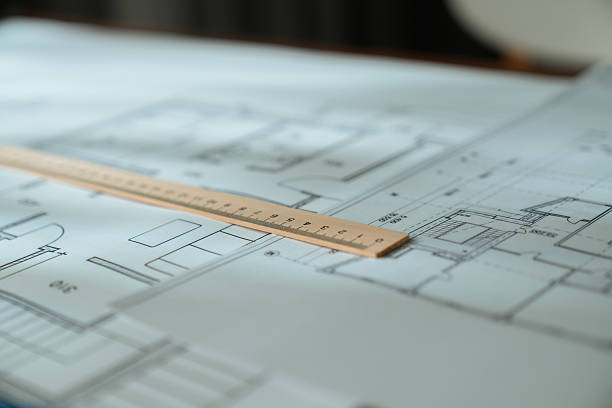 istock Architectural Blueprint with Wooden Ruler on Table 2217094532