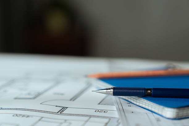 istock Architectural Blueprint with Wooden Ruler on Table 2217096093