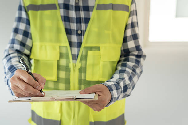 istock inspector or engineer is inspecting construction and quality assurance new house using a checklist. Engineers or architects or contactor work to build the house before handing it over to the homeowner 2217096690