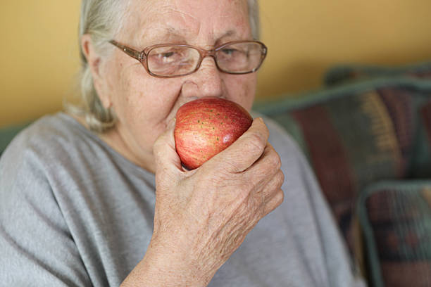 istock Old Woman 80+ with an Apple 2217097245