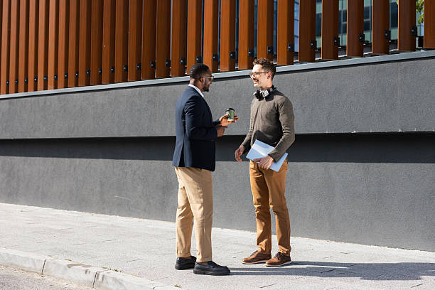 istock Two businessmen engaging in conversation outside an office building 2217099942