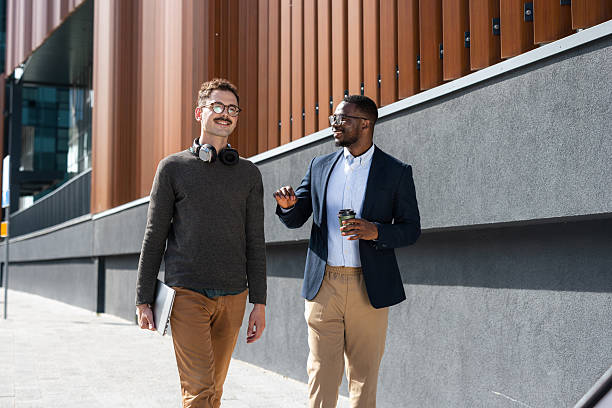istock Two diverse coworkers talking on a coffee break 2217099966