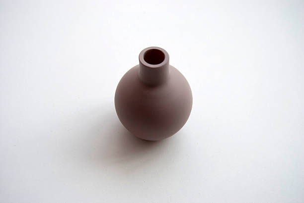 istock A small clay pot isolated on a white background. A tiny brown vase. 2217101450