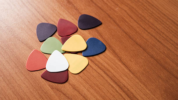 istock Colorful guitar picks arranged wooden surface artistic still life creative space close-up view 2217103229