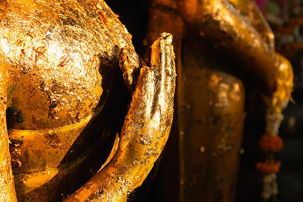 istock Golden buddha statue offering in tranquil temple setting cultural heritage close-up perspective 2217103660